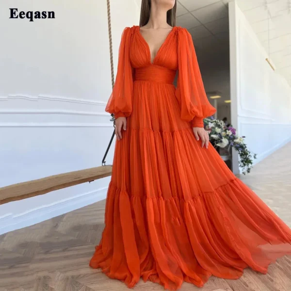Orange prom dresses with pleated chiffon, puff sleeves, and V-neck